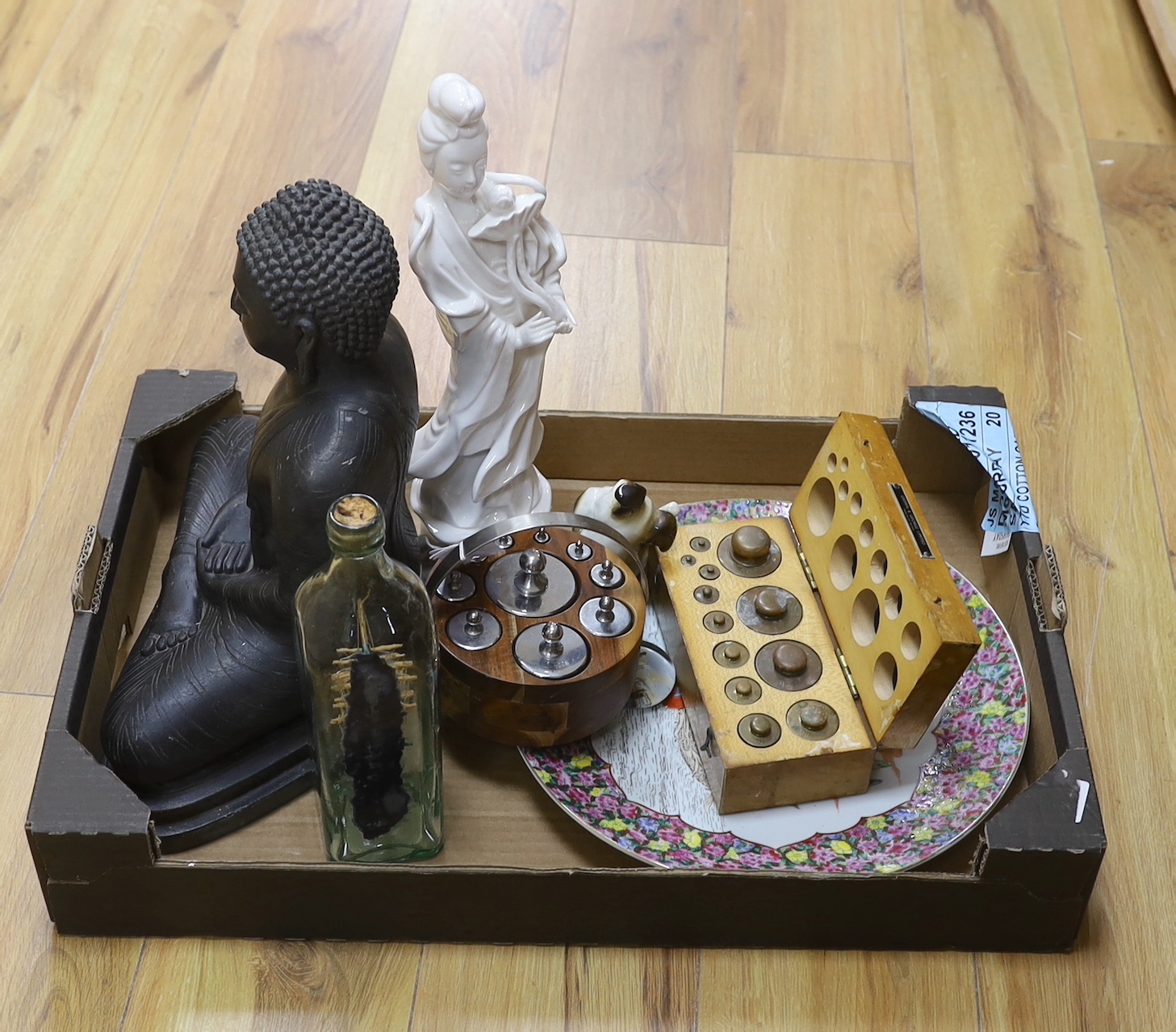 Sundry items including two graduated sets of weights, a ship-in-bottle, a large cast Buddha and a blanc de Chine figure, the largest 37cm high